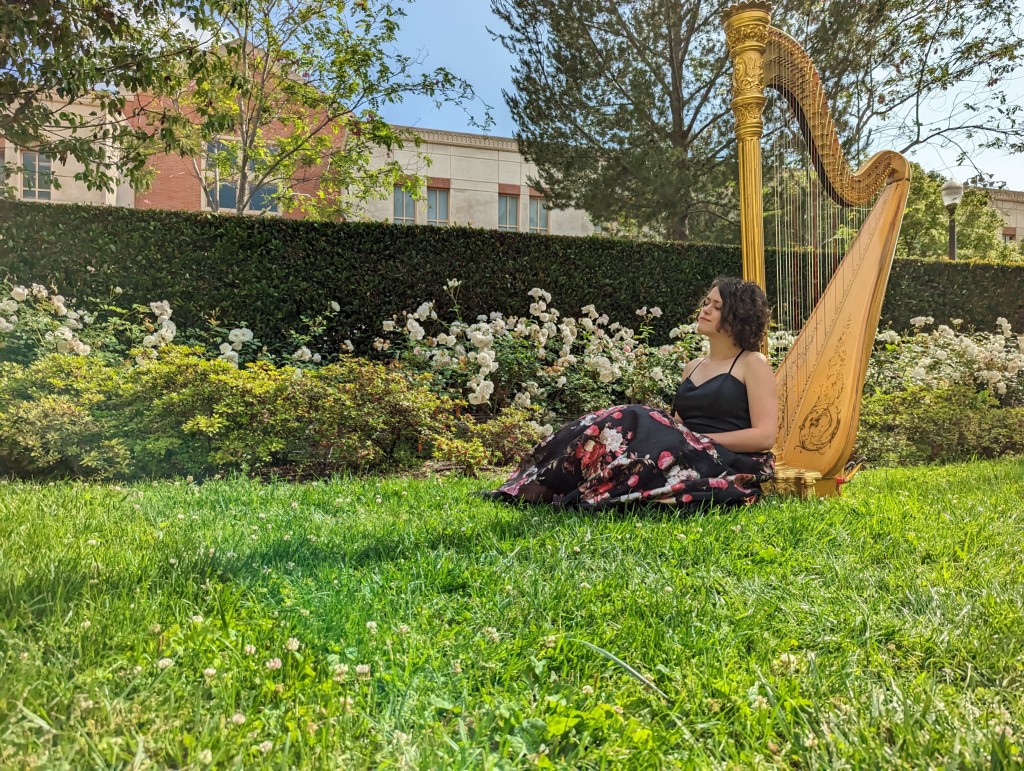 Kaitlin with harp in a garden